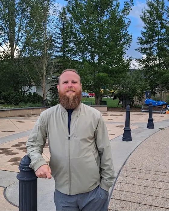 Martin Tippet outdoors beside a waterfront walkway
